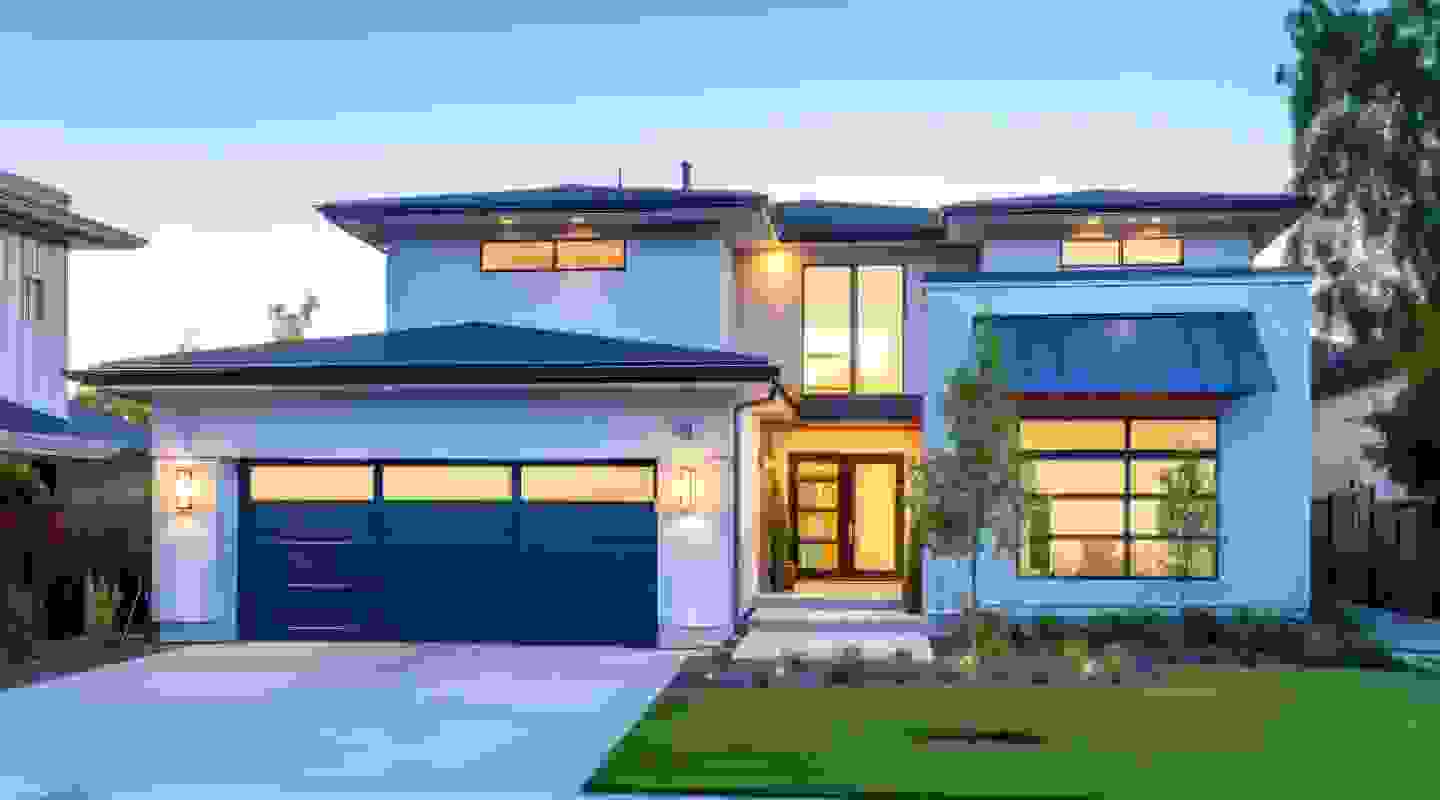 Modern townhouses with wooden and white facades, panoramic windows, and a landscaped walkway.